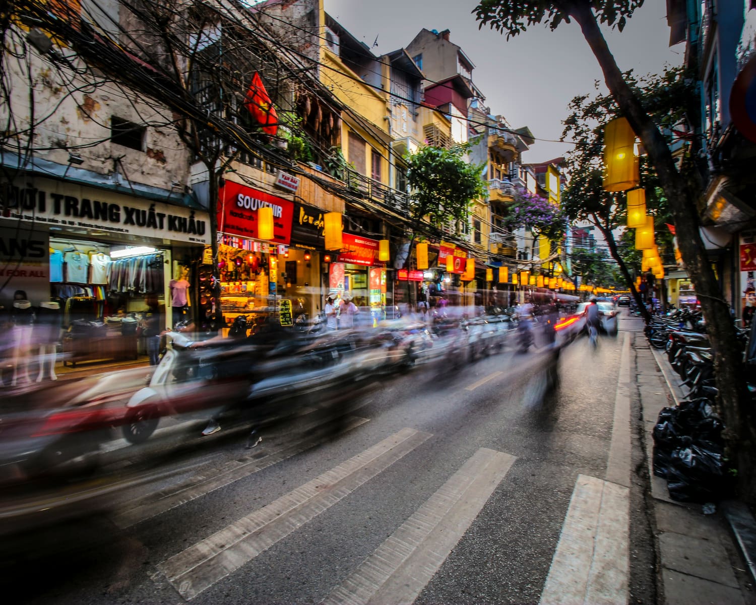 A busy Southeast Asian city street lined with shops