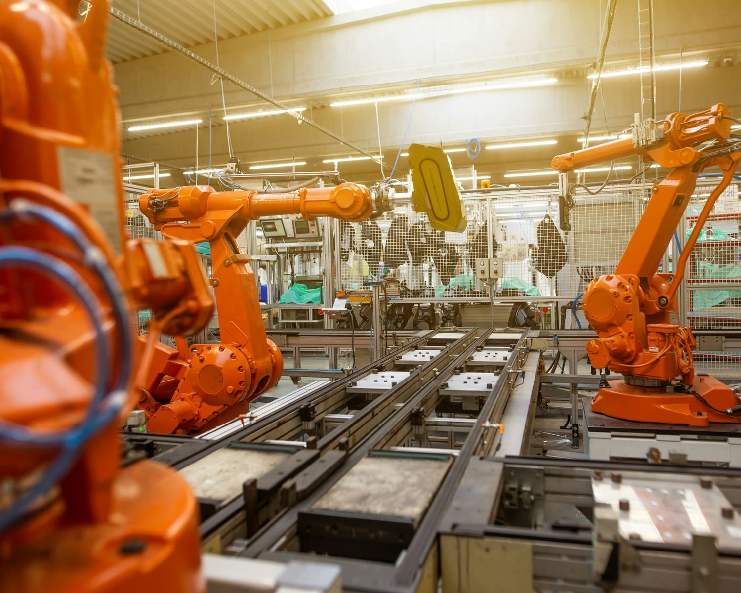 Industrial robotic arms operating along a factory line